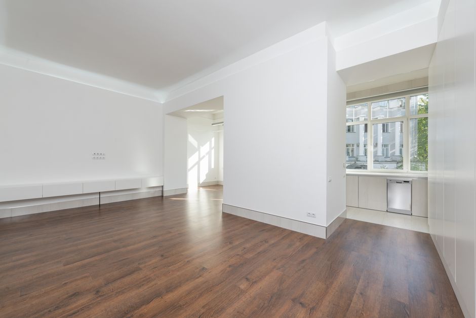 A modern, newly built-looking room with hardwood flooring