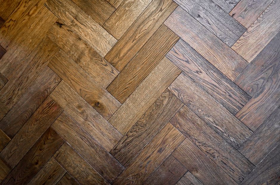 Close-up of a herringbone-pattern hardwood floor