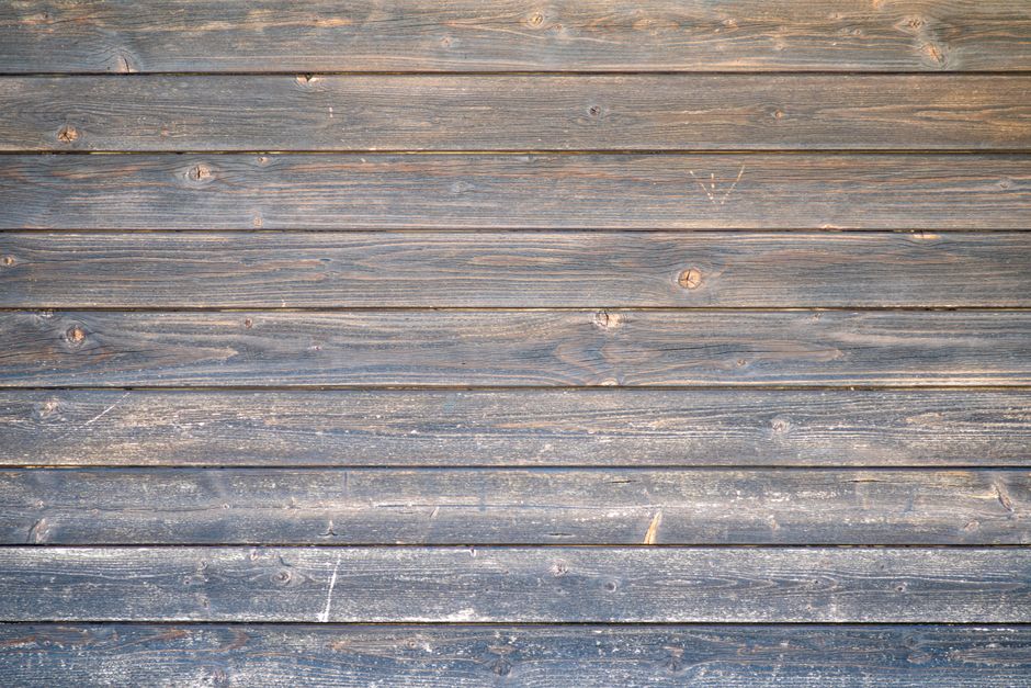 A weathered hardwood plank floor
