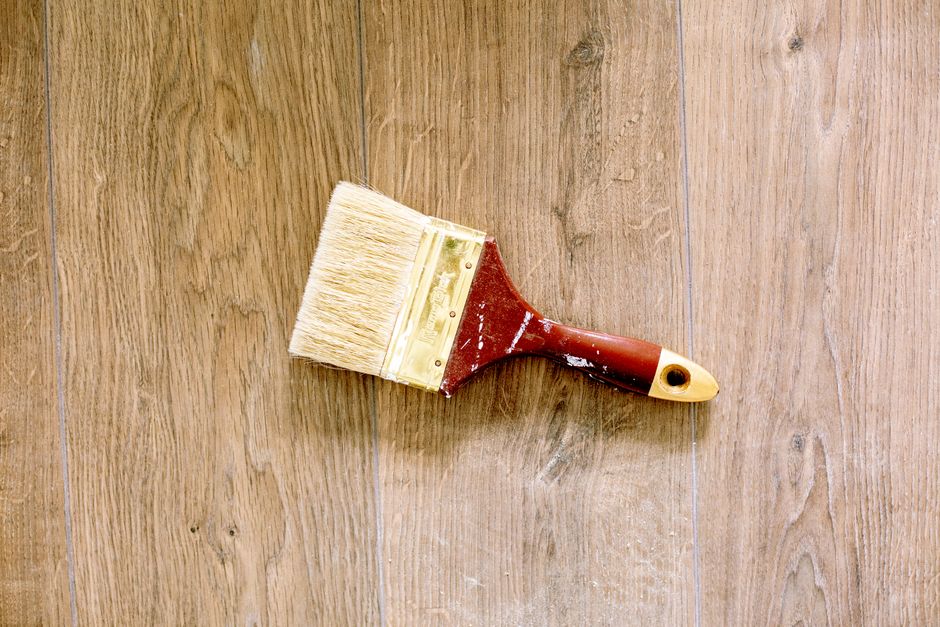 Two sections of hardwood flooring showing a difference in finish tone, one clearer and one with an amber cast