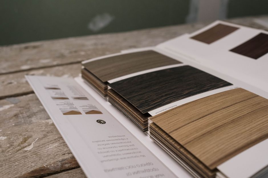 A stack of hardwood flooring samples in different stains