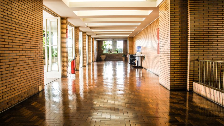 A glossy, recently recoated parquet hallway floor