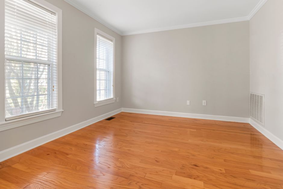 A bright room with hardwood flooring